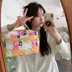 Detailed shot of a colorful quilted patchwork cotton makeup bag with floral patterns