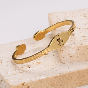 Detailed macro view of gold snake-style bracelet with hexagonal honeycomb textured pattern