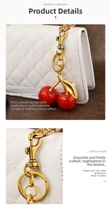 Detail of red cherry resin pendant and vintage gold clasp on white quilted leather bag