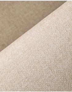 Close-up of beige woven fabric texture with soft plush detail and natural fibers