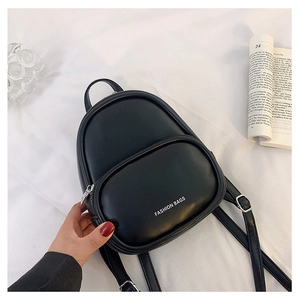 Close-up of black mini PU leather backpack with silver zippers and adjustable straps