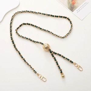 Detail of adjustable dark green leather and gold metal chain strap with diamond buckle