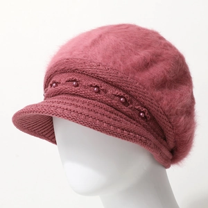 Women's pink knit winter beanie hat with plush top and elegant pearl accents