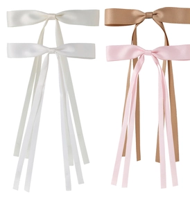 Detail of satin bow hair clips in cream, white, khaki, and pink colors with long ribbons