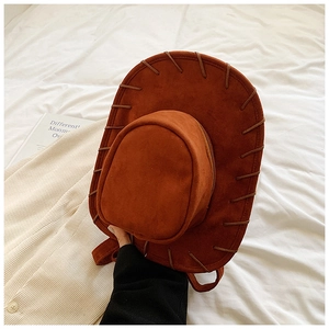 Detailed view of brown cowboy hat-shaped woven backpack made of soft faux suede material
