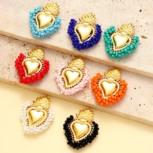 Handmade heart-shaped pendants with colorful beads and golden metal finish