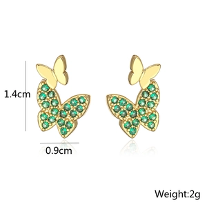 Detail showing 1.4cm by 0.9cm dimensions of gold butterfly earrings with green stones