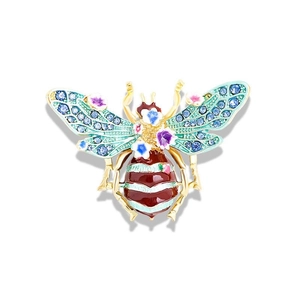 Luxurious gold bee brooch with blue crystal wings and colorful floral enamel details