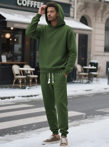 Detail of army green tracksuit showing waffle knit texture on hoodie and joggers set