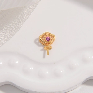 Macro shot of gold hollow cloud pattern jewelry base with central purple zircon stone