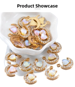 Detailed macro view of 19mm gold alloy moon pendants with iridescent heart stone inlay