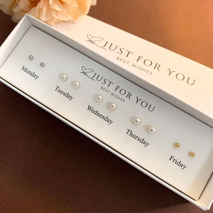 Detail of 5-pair weekday earring set with pearls and metal studs in a white gift box