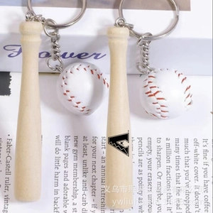 Macro detail of mini wooden baseball bat with logo and white PU ball on keychain