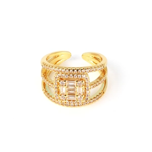 Close-up of gold-plated multi-layer open ring with square micro-pave zircons