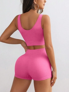 Detailed back view of pink ribbed knit seamless sports vest and high waist yoga shorts set