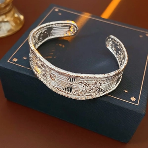 Detailed macro view of retro textured silver cuff bracelet on dark blue jewelry gift box