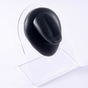 Macro view of black silicone tongue model on acrylic stand for piercing practice