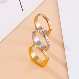 Set of three minimalist wide band stainless steel rings in gold, silver, and rose gold
