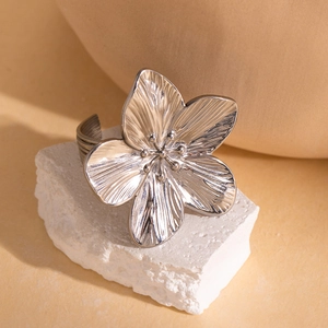 Detailed close-up of a vintage silver flower ring with intricate petal textures on stone