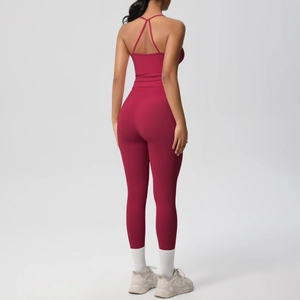 Detail view of deep rose red sports set featuring cross back bra and high-waist leggings
