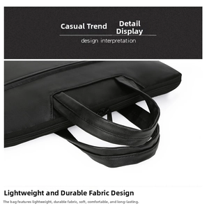Close-up of durable dual-handle design and high-quality stitching on black laptop bag