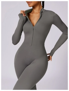 Detail of the front zipper and thumbholes on this high-stretch dark grey yoga bodysuit