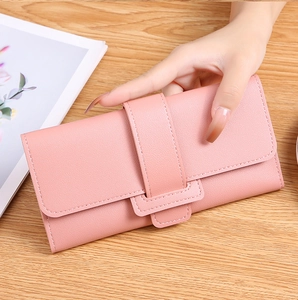 Close-up of pink long wallet with litchi grain texture and decorative buckle detail