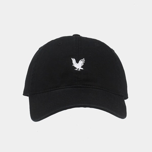 Close-up of the detailed white eagle embroidery on the black cotton baseball cap