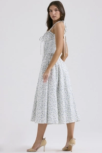 Detail of white floral sundress showing halter neck ties and backless summer style