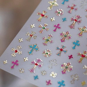 Frosted nail stickers with gold embossed cross designs and colorful gemstone textures