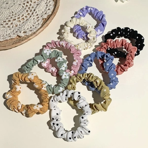 Floral and polka dot scrunchie set in soft pastel colors for hair styling
