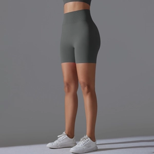 Detail view showing seamless knit high-waist band on dark grey yoga shorts for women
