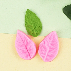 Leaf silicone mold for fondant showing realistic vein texture and finished green leaf model