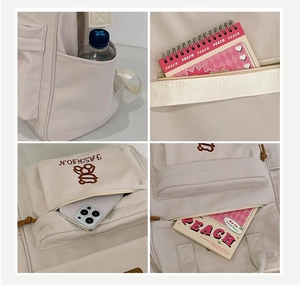 Detail of beige nylon school backpack showing side pockets and embroidered logo