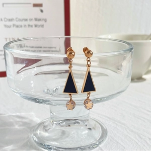 Golden geometric triangle drop earrings with black enamel and zircon stars