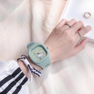 Close-up of mint green silicone watch with square dial worn on wrist in a lifestyle setting