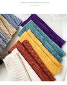 Flat lay of colorful ribbed knit wrist warmers in various autumn shades and textures