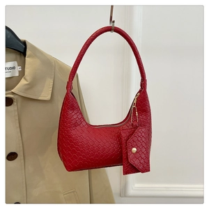 Chic red woven texture shoulder bag with small coin purse hanging on a coat hook