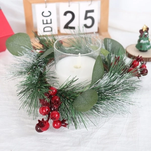Christmas candle ring with artificial pine needles, eucalyptus leaves and red berries