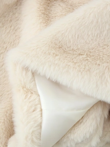 Detail of plush faux fur texture with smooth satin lining on beige women's winter coat