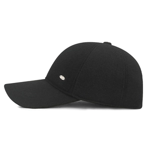 Men's winter baseball cap in black knit texture with ear flaps and metal side plaque