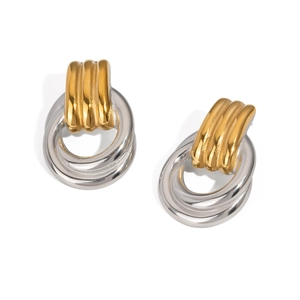 Detail of two-tone gold and silver circular drop earrings with textured gold connectors