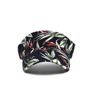 Detailed view of tropical floral print and texture on the black sun visor cap