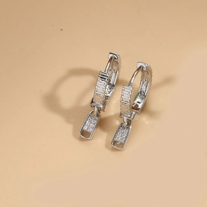 Macro shot of silver zipper pull earrings with sparkling pave white zircon stones