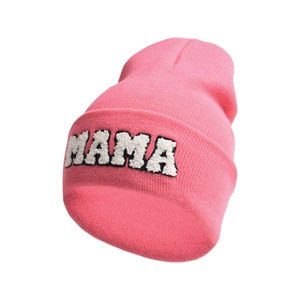 Detailed close-up of pink knit beanie with MAMA letter embroidery and soft texture