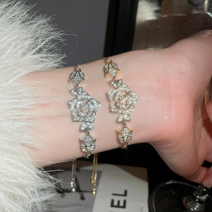 Detail of elegant rose flower bracelet with sparkling zircons and adjustable chain