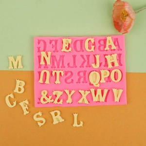 Pink silicone alphabet mold with scalloped edge letters for chocolate and fondant baking