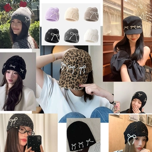 Collection of knit beanies and berets with elegant pearl bow accents in various colors