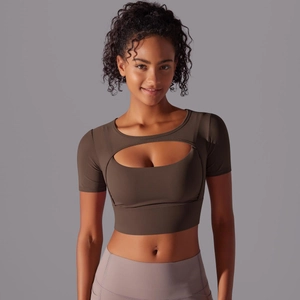 Detail of dark brown short sleeve yoga crop top with front cutout and layered design