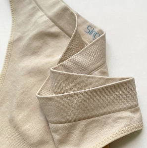 Macro detail of seamless ribbed stretch thong featuring wavy edges and fine knit texture